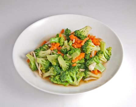 Fried Map BROCCOLI put on a plate, white carrots.