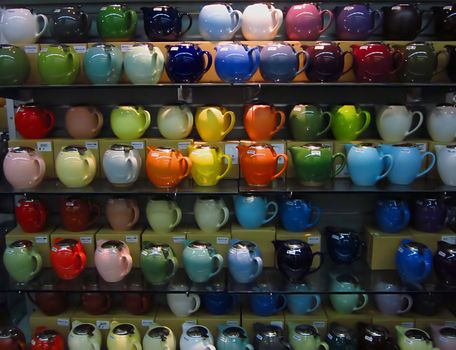 A photograph of various teapots for sale in a grocery store.