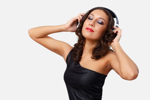 Portrait of young woman with headphones in studio