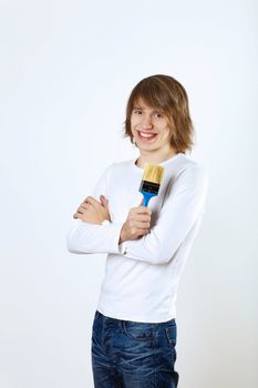 Portrait of young man with paint brushes