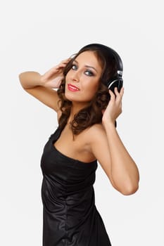 Portrait of young woman with headphones in studio