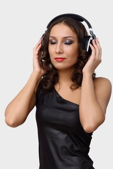 Portrait of young woman with headphones in studio