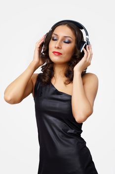 Portrait of young woman with headphones in studio