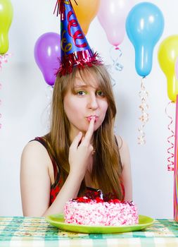 Birthday. A young attractive girl eating cake with your fingers