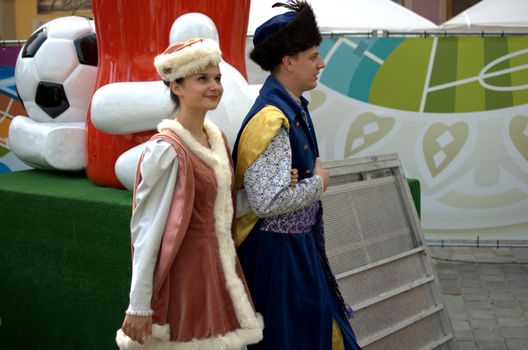 WROCLAW, POLAND - JUNE 15:  Couple in traditional uniforms visit Euro 2012 fanzone on June 15, 2012 in Wroclaw.  