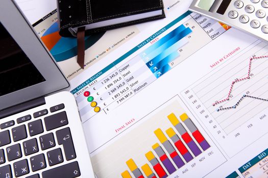 Financial paper charts and graphs on the table