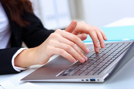 Young pretty business woman with notebook in the office