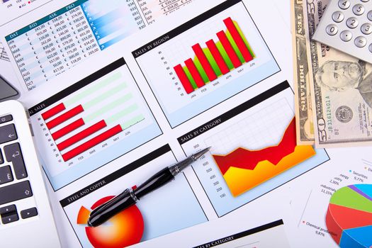 Financial paper charts and graphs on the table