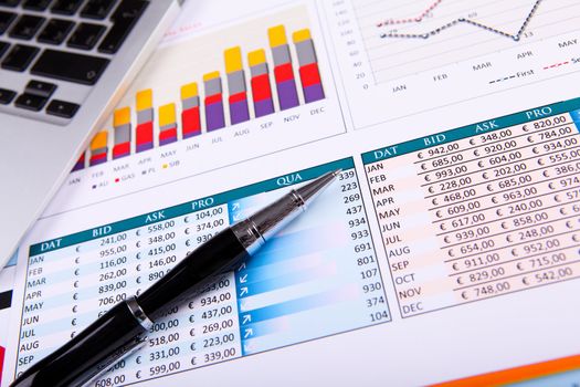 Financial paper charts and graphs on the table