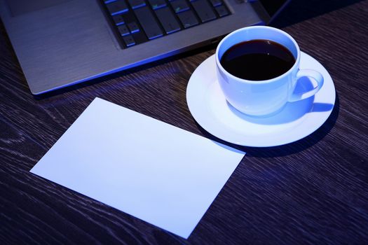 White cup with black coffee at business workplace