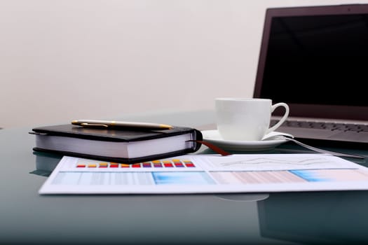 Image of business table with a cup of coffee and norebook