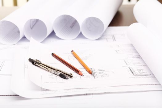 Tools and papers with sketches on the table