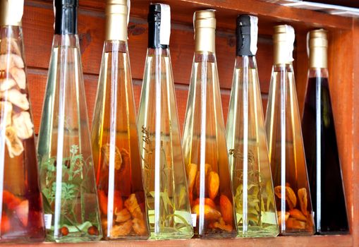 colorful liqueur and vinegar bottles on a market in croatia.