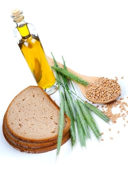 tasty baked bread with ears and wheat grain, isolated on a white background