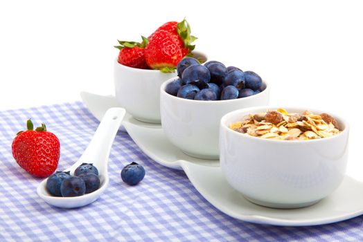 fresh berries in porcelain bowls, isolated on white background