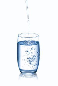 Photograph of pouring water into glass, isolated over white