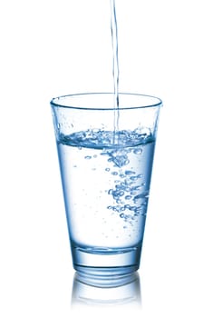 Photograph of pouring water into glass, isolated over white