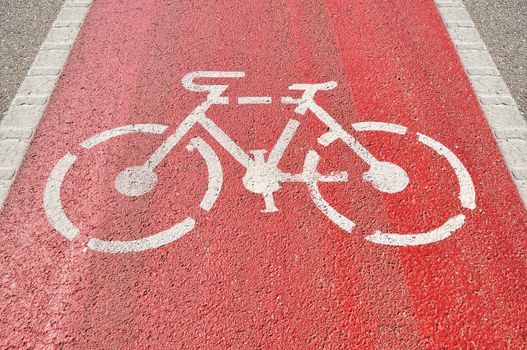 Bicycle lane sign on red asphalt