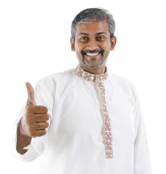 Excited thumb up Indian man in traditional costume kurta dhoti isolated on white background