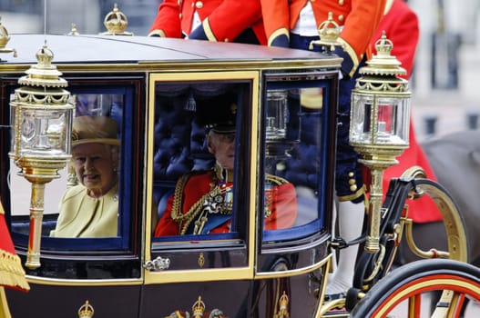 LONDON, UK - June 16: Queen Elizabeth II and the Duke of Edinburgh during Trooping the Colour ceremony on the Mall and at Buckingham Palace, on June 16, 2012 in London. Trooping the Colour takes place every year in June to officialy celebrate the sovereign birthday.