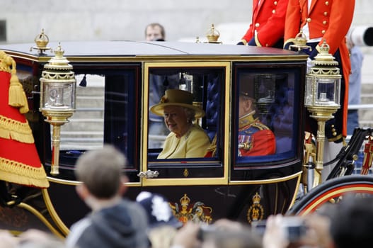 LONDON, UK - June 16: Queen Elizabeth II and the Duke of Edinburgh during Trooping the Colour ceremony on the Mall and at Buckingham Palace, on June 16, 2012 in London. Trooping the Colour takes place every year in June to officialy celebrate the sovereign birthday.