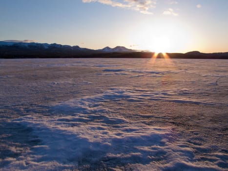 Vast ice surface of huge frozen Lake Laberge,  Yukon Territory, Canada, in April