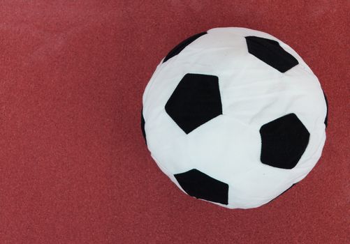 soccer ball with red cork board