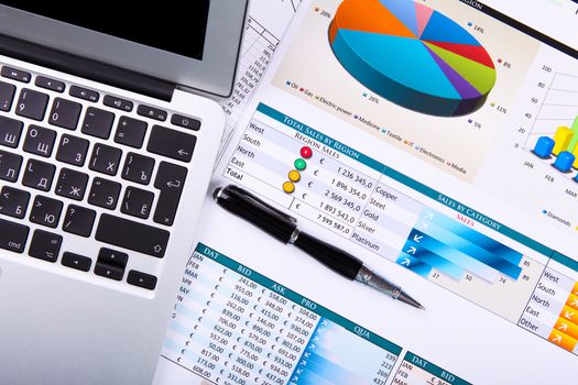 Financial paper charts and graphs on the table