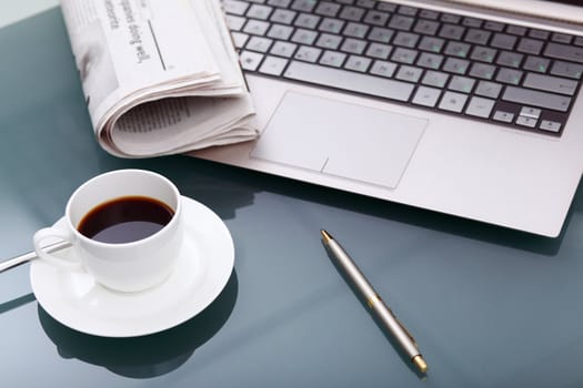 Image of business table with a cup of coffee and norebook