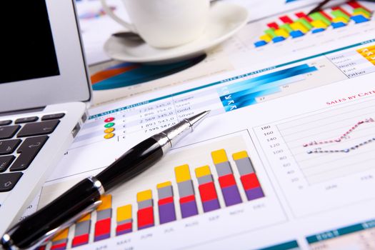 Financial paper charts and graphs on the table