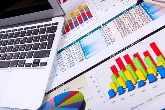 Financial paper charts and graphs on the table