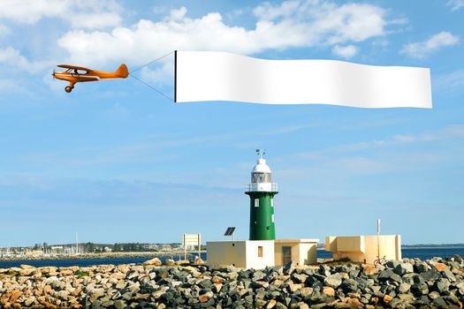 Plane in the sky above the city with blank flag