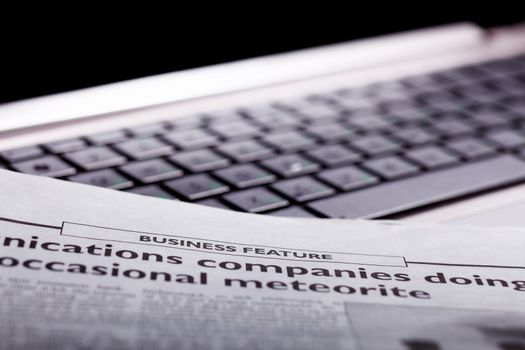 Notebook keyboard with a newspaper on it