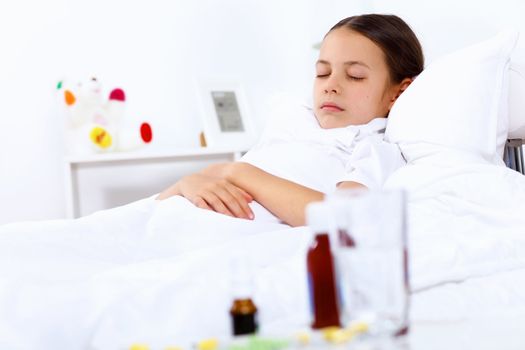 Little girl with illness at bed at home