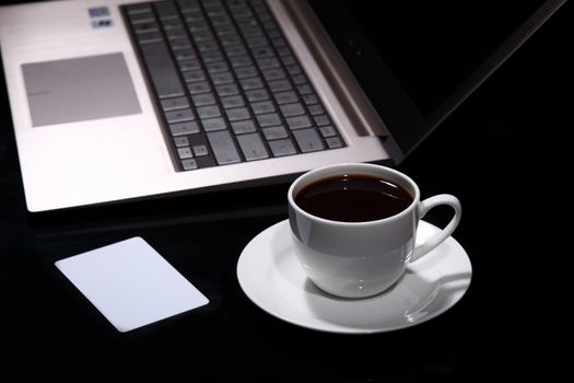 White cup with black coffee at business workplace