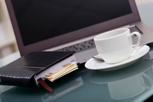 Image of business table with a cup of coffee and norebook