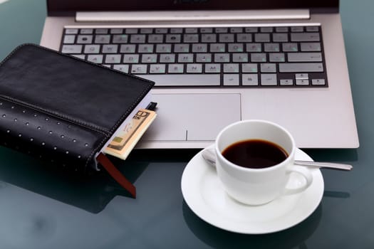 Image of business table with a cup of coffee and norebook