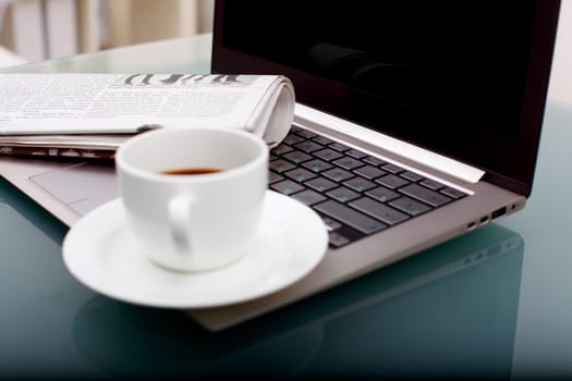 Image of business table with a cup of coffee and norebook