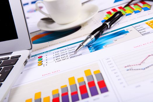 Financial paper charts and graphs on the table