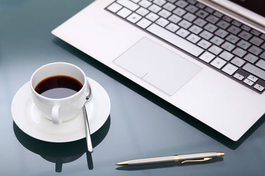 Image of business table with a cup of coffee and norebook