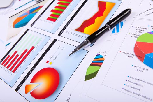 Financial paper charts and graphs on the table