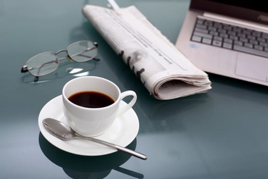 Image of business table with a cup of coffee and norebook