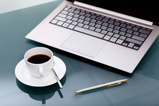 Image of business table with a cup of coffee and norebook