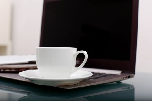 Image of business table with a cup of coffee and norebook