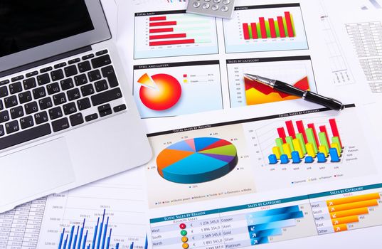 Financial paper charts and graphs on the table