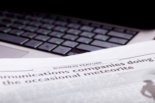 Notebook keyboard with a newspaper on it