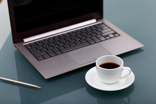 Image of business table with a cup of coffee and norebook