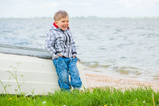 Cute little boy sitting on the boat
