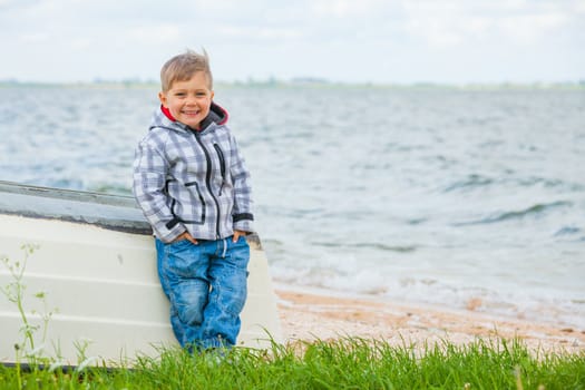 Cute little boy sitting on the boat