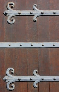 Antique Door background with massive metal Hinges in Bruges, Belgium.